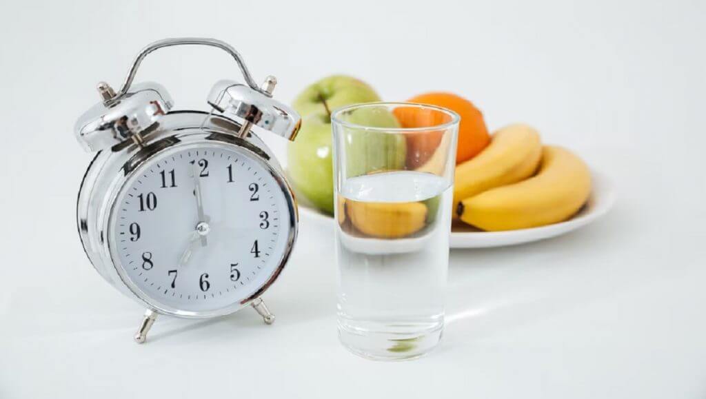 alarm-glass-water-near-fruits