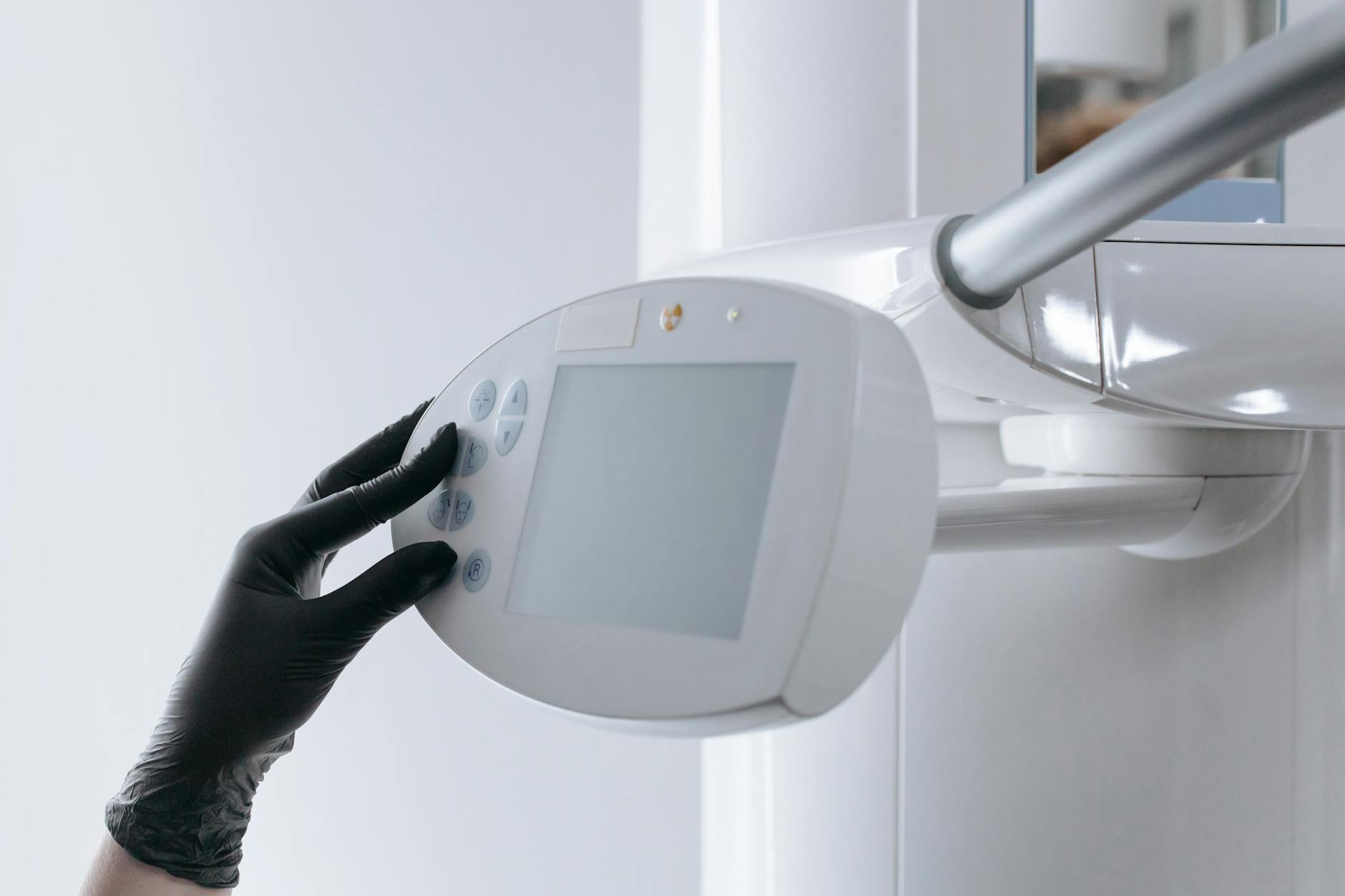 close up shot of a person using a dental x ray machine